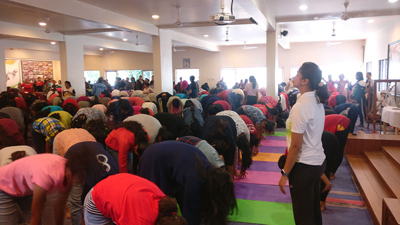 Students while performing Pada-Hastasana