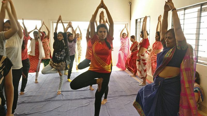 Students and Staff while performing Vriksasana 