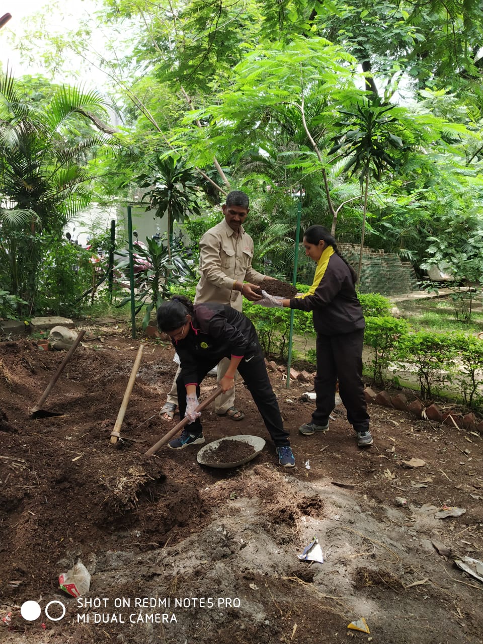 Green Club members and staff harvesting manure