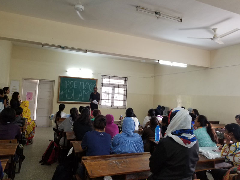 The audience listening intently to a participant at the Poetry Slam